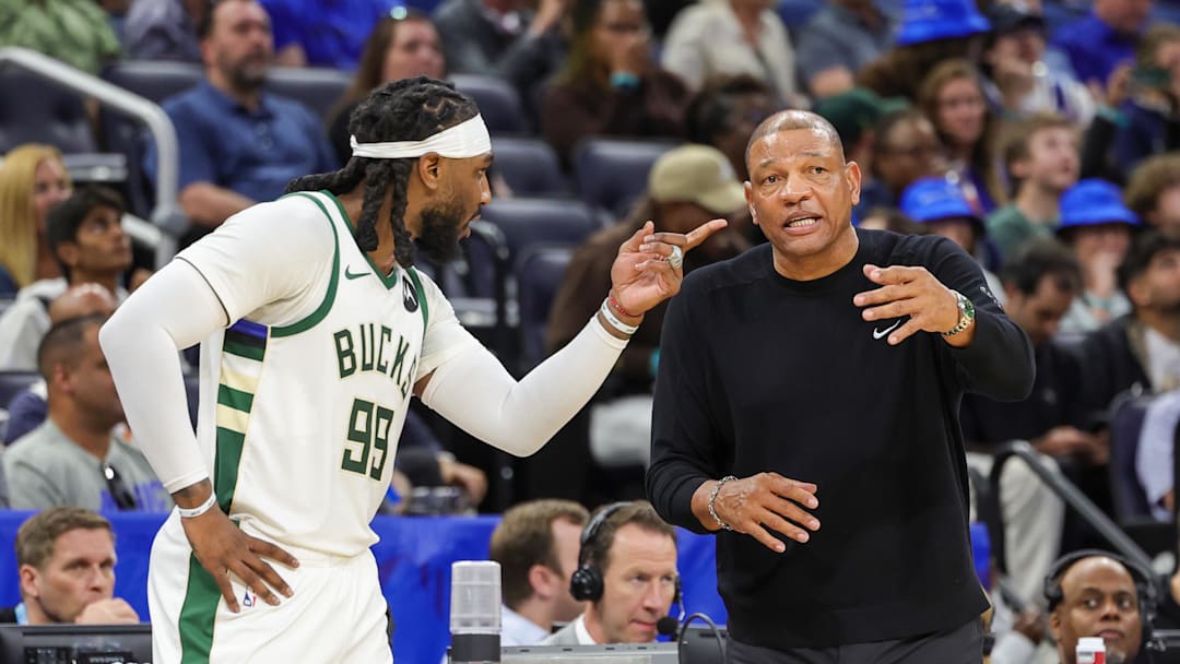 Apr 14, 2024; Orlando, Florida, USA; Milwaukee Bucks head coach Doc Rivers talks with Milwaukee Bucks forward Jae Crowder (99) during the second quarter against the Orlando Magic at KIA Center. Mandatory Credit: Mike Watters-Imagn Images