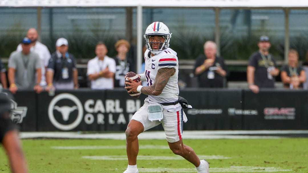 Nov 2, 2024; Orlando, Florida, USA; Arizona Wildcats quarterback Noah Fifita (11) rolls out to pass against the UCF Knights during the second quarter at FBC Mortgage Stadium. Mandatory Credit: Mike Watters-Imagn Images