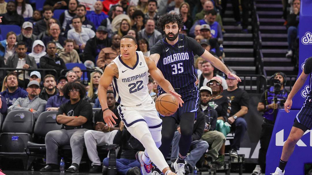 Feb 21, 2025; Orlando, Florida, USA; Memphis Grizzlies guard Desmond Bane (22) moves the ball in front of Orlando Magic center Goga Bitadze (35) during the second quarter at Kia Center. Mandatory Credit: Mike Watters-Imagn Images