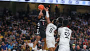 Feb 5, 2025; Orlando, Florida, USA; Cincinnati Bearcats guard Day Day Thomas (1) shoots against UCF Knights guard Jordan Ivy-Curry (0) during the first half at Addition Financial Arena. Mandatory Credit: Mike Watters-Imagn Images