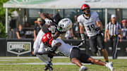 Oct 12, 2024; Orlando, Florida, USA; UCF Knights wide receiver Kobe Hudson (2) is tackled by Cincinnati Bearcats defensive back Derrick Canteen (10) during the second quarter  at FBC Mortgage Stadium. Mandatory Credit: Mike Watters-Imagn Images