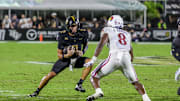 Oct 4, 2025; Orlando, Florida, USA; UCF Knights quarterback Tayven Jackson (2) runs the ball in front of Kansas Jayhawks linebacker Jon Jon Kamara (8) during the second quarter at FBC Mortgage Stadium. Mandatory Credit: Mike Watters-Imagn Images