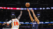 Apr 8, 2025; Orlando, Florida, USA; Orlando Magic guard Caleb Houstan (2) shoots a three point basket against Atlanta Hawks forward Mouhamed Gueye (18) during the second half at Kia Center. Mandatory Credit: Mike Watters-Imagn Images