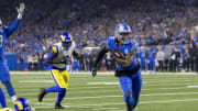 Jan 14, 2024; Detroit, Michigan, USA; Detroit Lions running back Jahmyr Gibbs (26) runs for a touchdown against Los Angeles Rams safety Russ Yeast (2) during the first half of a 2024 NFC wild card game at Ford Field. Mandatory Credit: David Reginek-USA TODAY Sports