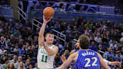 Nov 9, 2025; Orlando, Florida, USA; Boston Celtics guard Payton Pritchard (11) passes the ball over Orlando Magic forward Franz Wagner (22) during the first quarter at Kia Center. Mandatory Credit: Mike Watters-Imagn Images