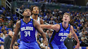Oct 25, 2024; Orlando, Florida, USA; Orlando Magic center Wendell Carter Jr. (34), forward Franz Wagner (22) and Brooklyn Nets center Nic Claxton (33) watch for the rebound during the second quarter at Kia Center. Mandatory Credit: Mike Watters-Imagn Images