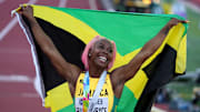 Shelly-Ann Fraser-Pryce carries the Jamaican flag during the 2022 World Championships.