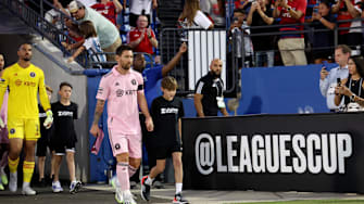 Aug 6, 2023; Frisco, TX, USA; Inter Miami CF forward Lionel Messi (10) walks onto the pitch with a kid before a match against FC Dallas at Toyota Stadium. Mandatory Credit: Kevin Jairaj-Imagn Images