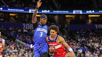 Feb 23, 2025; Orlando, Florida, USA; Washington Wizards guard Jordan Poole (13) drives past Orlando Magic guard Kentavious Caldwell-Pope (3) during the first quarter at Kia Center. Mandatory Credit: Mike Watters-Imagn Images