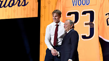 Jun 28, 2023; Nashville, Tennessee, USA; Nashville Predators draft pick Matthew Wood shakes hands with NHL commissioner Gary Bettman after being selected with the fifteenth pick in round one of the 2023 NHL Draft at Bridgestone Arena. Mandatory Credit: Christopher Hanewinckel-Imagn Images