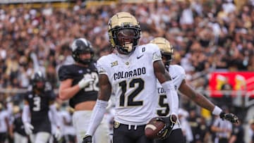 Sep 28, 2024; Orlando, Florida, USA; Colorado Buffaloes wide receiver Travis Hunter (12) scores a touchdown against the UCF Knights during the first quarter at FBC Mortgage Stadium. Mandatory Credit: Mike Watters-Imagn Images