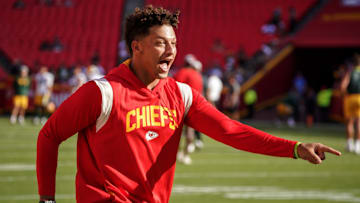 Aug 25, 2022; Kansas City, Missouri, USA; Kansas City Chiefs quarterback Patrick Mahomes (15) laughs after catching a pass over tight end Travis Kelce (not pictured) during warm ups before a preseason game against the Green Bay Packers at GEHA Field at Arrowhead Stadium. Mandatory Credit: Denny Medley-Imagn Images
