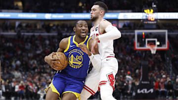 Jan 12, 2024; Chicago, Illinois, USA; Golden State Warriors forward Jonathan Kuminga (00) drives against Chicago Bulls guard Zach LaVine (8)