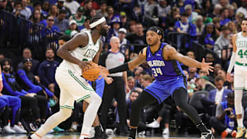 Apr 9, 2025; Orlando, Florida, USA; Orlando Magic center Wendell Carter Jr. (34) defends Boston Celtics center Neemias Queta (88) during the second half at Kia Center. Mandatory Credit: Mike Watters-Imagn Images