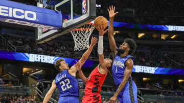 Apr 1, 2024; Orlando, Florida, USA; Portland Trail Blazers guard Dalano Banton (5) goes to the basket against Orlando Magic forward Franz Wagner (22) and forward Jonathan Isaac (1) during the second quarter at Amway Center. Mandatory Credit: Mike Watters-USA TODAY Sports