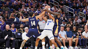 Oct 16, 2025; Orlando, Florida, USA; Orlando Magic guard Anthony Black (0) is defended by New Orleans Pelicans guard/forward Micah Peavy (14) and forward Zion Williamson (1) during the second quarter at Kia Center. Mandatory Credit: Mike Watters-Imagn Images