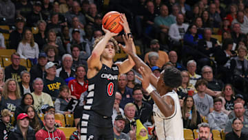 Feb 17, 2024; Orlando, Florida, USA; Cincinnati Bearcats guard Dan Skillings Jr. (0) shoots the ball against UCF Knights forward Marchelus Avery (13) during the first half at Addition Financial Arena. Mandatory Credit: Mike Watters-Imagn Images