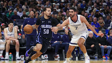 Feb 21, 2025; Orlando, Florida, USA; Orlando Magic guard Cole Anthony (50) drives around Memphis Grizzlies forward Santi Aldama (7) during the second quarter at Kia Center. Mandatory Credit: Mike Watters-Imagn Images