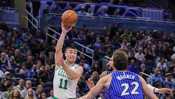 Nov 9, 2025; Orlando, Florida, USA; Boston Celtics guard Payton Pritchard (11) passes the ball over Orlando Magic forward Franz Wagner (22) during the first quarter at Kia Center. Mandatory Credit: Mike Watters-Imagn Images