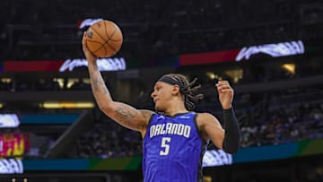 Orlando Magic forward Paolo Banchero grabs the rebound against the Boston Celtics.
