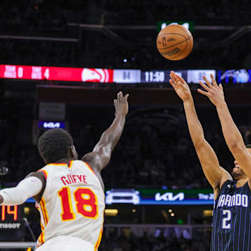 Apr 8, 2025; Orlando, Florida, USA; Orlando Magic guard Caleb Houstan (2) shoots a three point basket against Atlanta Hawks forward Mouhamed Gueye (18) during the second half at Kia Center. Mandatory Credit: Mike Watters-Imagn Images
