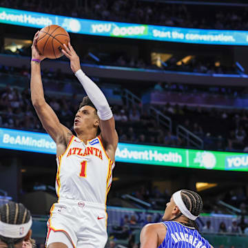 Oct 24, 2025; Orlando, Florida, USA; Atlanta Hawks forward Jalen Johnson (1) goes to the basket in front of Orlando Magic forward Paolo Banchero (5) during the first quarter at Kia Center. Mandatory Credit: Mike Watters-Imagn Images