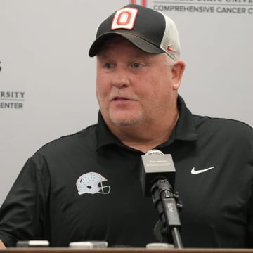 Aug 15, 2024; Columbus, Ohio, USA; Ohio State University football team offensive coordinator Chip Kelly uses three fingers to remind people that Cardale Jones was the number three quarterback when he led the Ohio State team to the championship. Kelly talked with the media Aug. 15, 2024 in the team meeting room.