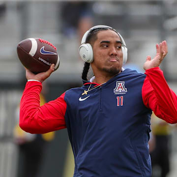 Nov 2, 2024; Orlando, Florida, USA; Arizona Wildcats quarterback Noah Fifita (11) warms up before the game against the UCF Knights at FBC Mortgage Stadium. Mandatory Credit: Mike Watters-Imagn Images
