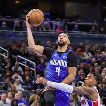 Jan 25, 2025; Orlando, Florida, USA; Orlando Magic guard Jalen Suggs (4) is fouled by Detroit Pistons guard Marcus Sasser (25) during the second half at Kia Center. Mandatory Credit: Mike Watters-Imagn Images