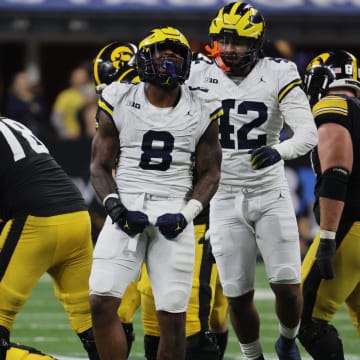 Dec 2, 2023; Indianapolis, IN, USA; Michigan Wolverines defensive end Derrick Moore (8) celebrates after sacking Iowa Hawkeyes quarterback Deacon Hill (10) during the second half of the Big Ten Championship game at Lucas Oil Stadium. Mandatory Credit: Trevor Ruszkowski-USA TODAY Sports