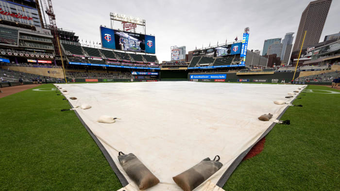 May 13, 2023; Minneapolis, Minnesota, USA; A tarp covers the infield during a rain delay before a game between the Chicago Cubs vs Minnesota Twins at Target Field. Mandatory Credit: Jordan Johnson-USA TODAY Sports