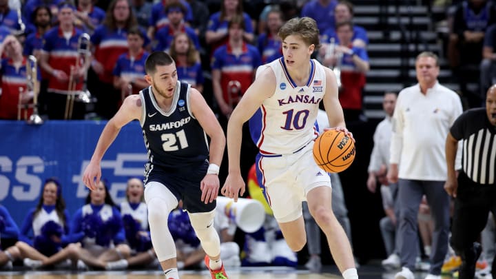 Mar 21, 2024; Salt Lake City, UT, USA; Kansas Jayhawks guard Johnny Furphy (10) dribbles against Samford Bulldogs guard Rylan Jones (21) during the first half in the first round of the 2024 NCAA Tournament at Vivint Smart Home Arena-Delta Center. Mandatory Credit: Rob Gray-USA TODAY Sports
