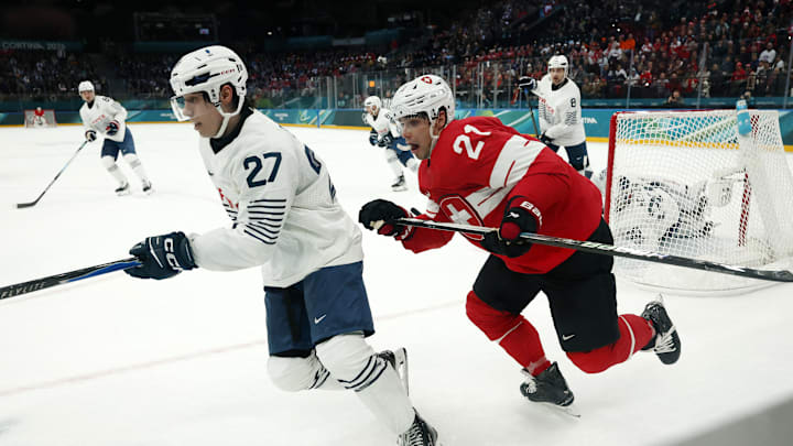 Feb 12, 2026; Milan, Italy; Jules Boscq of France in action with Kevin Fiala of Switzerland during a Group A men's ice hockey game during the Milano Cortina 2026 Olympic Winter Games at Milano Santagiulia Ice Hockey Arena. Mandatory Credit: Geoff Burke-Imagn Images