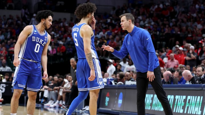 Mar 29, 2024; Dallas, TX, USA; Duke Blue Devils head coach Jon Scheyer talks to guard Jared McCain (0) and guard Tyrese Proctor (5) during the second half in the semifinals of the South Regional of the 2024 NCAA Tournament against the Houston Cougars at American Airlines Center. Mandatory Credit: Tim Heitman-USA TODAY Sports 