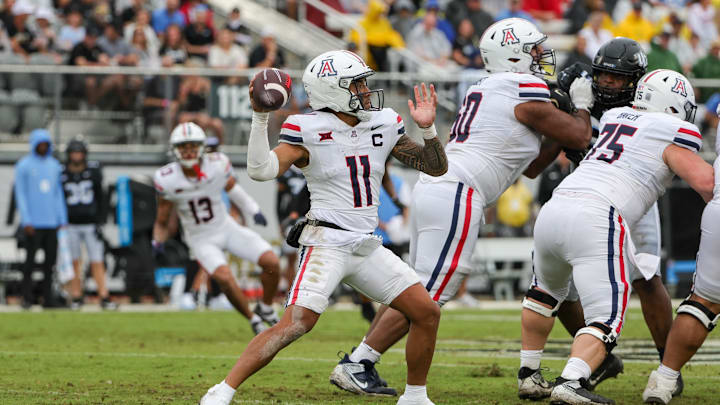 Nov 2, 2024; Orlando, Florida, USA; Arizona Wildcats quarterback Noah Fifita (11) throws a pass against the UCF Knights during the second quarter at FBC Mortgage Stadium. Mandatory Credit: Mike Watters-Imagn Images