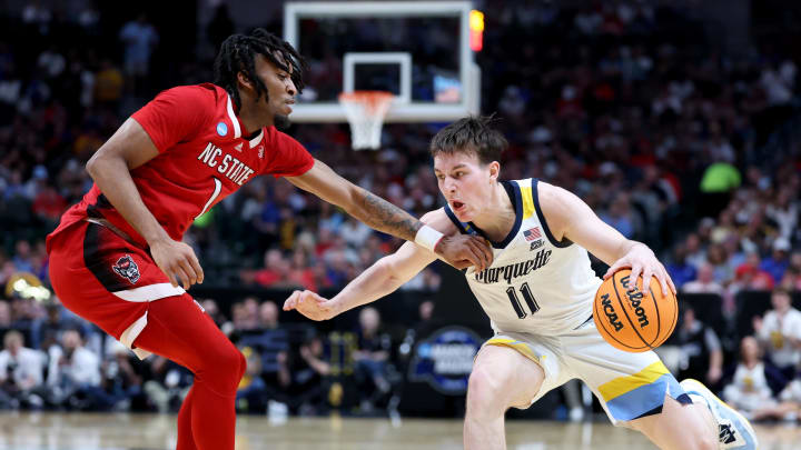 Mar 29, 2024; Dallas, TX, USA; Marquette Golden Eagles guard Tyler Kolek (11) drives against North Carolina State Wolfpack guard Jayden Taylor (1) during the first half in the semifinals of the South Regional of the 2024 NCAA Tournament at American Airlines Center. Mandatory Credit: Kevin Jairaj-USA TODAY Sports 