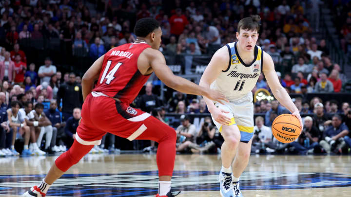 Mar 29, 2024; Dallas, TX, USA; Marquette Golden Eagles guard Tyler Kolek (11) dribbles against North Carolina State Wolfpack guard Casey Morsell (14) during the first half in the semifinals of the South Regional of the 2024 NCAA Tournament at American Airlines Center. Mandatory Credit: Kevin Jairaj-USA TODAY Sports 