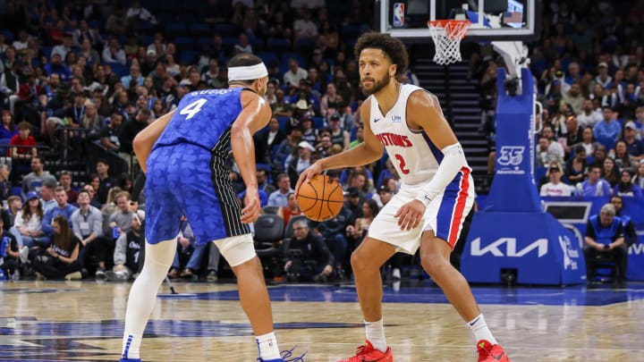 Mar 3, 2024; Orlando, Florida, USA; Detroit Pistons guard Cade Cunningham (2) handles the ball in front of Orlando Magic guard Jalen Suggs (4) during the second half at KIA Center. Mandatory Credit: Mike Watters-USA TODAY Sports