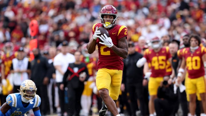 Nov 18, 2023; Los Angeles, California, USA; USC Trojans wide receiver Brenden Rice (2) catches a touchdown against UCLA Bruins defensive back Jaylin Davies (24) during the second quarter at United Airlines Field at Los Angeles Memorial Coliseum. Mandatory Credit: Jason Parkhurst-USA TODAY Sports