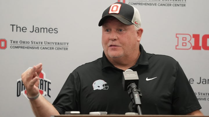 Aug 15, 2024; Columbus, Ohio, USA; Ohio State University football team offensive coordinator Chip Kelly uses three fingers to remind people that Cardale Jones was the number three quarterback when he led the Ohio State team to the championship. Kelly talked with the media Aug. 15, 2024 in the team meeting room.