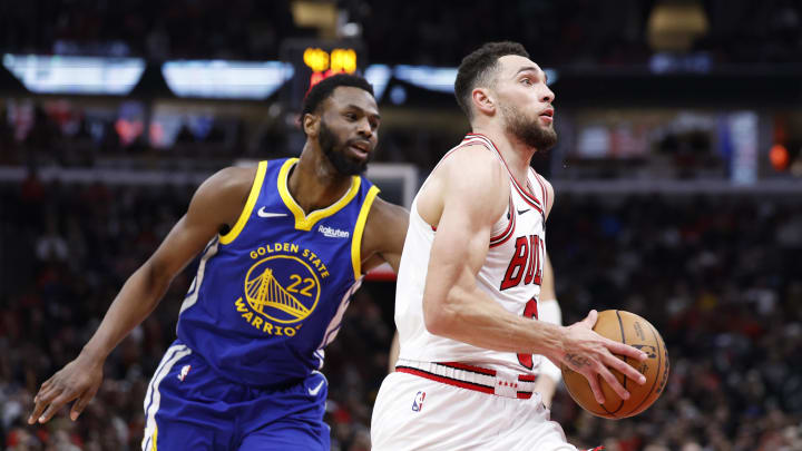 Jan 12, 2024; Chicago, Illinois, USA; Chicago Bulls guard Zach LaVine (8) drives against Golden State Warriors forward Andrew Wiggins (22) during the second half at United Center. 