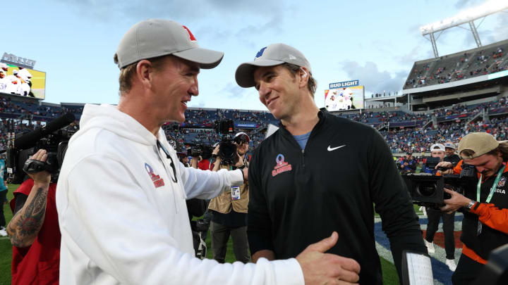 Feb 4, 2024; Orlando, FL, USA; NFC coach Eli Manning and AFC coach Peyton Manning react after the 2024 Pro Bowl at Camping World Stadium.  