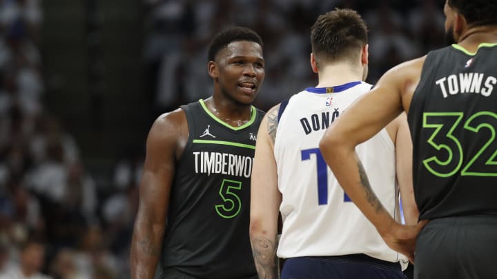 May 30, 2024; Minneapolis, Minnesota, USA; Minnesota Timberwolves guard Anthony Edwards (5) talks to Dallas Mavericks guard Luka Doncic (77) during the second quarter in game five of the western conference finals for the 2024 NBA playoffs at Target Center. Mandatory Credit: Bruce Kluckhohn-USA TODAY Sports
