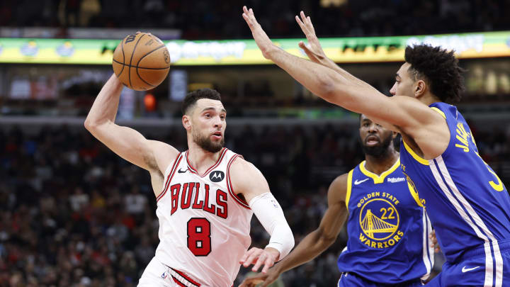 Jan 12, 2024; Chicago, Illinois, USA; Chicago Bulls guard Zach LaVine (8) drives against Golden State Warriors forward Trayce Jackson-Davis (32) during the second half at United Center. Mandatory Credit: Kamil Krzaczynski-USA TODAY Sports