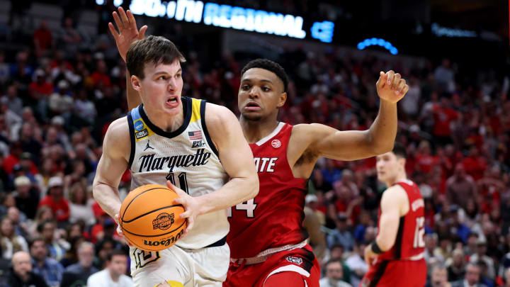 Mar 29, 2024; Dallas, TX, USA; Marquette Golden Eagles guard Tyler Kolek (11) drives against North Carolina State Wolfpack guard Casey Morsell (14) during the second half in the semifinals of the South Regional of the 2024 NCAA Tournament at American Airlines Center. Mandatory Credit: Tim Heitman-USA TODAY Sports 