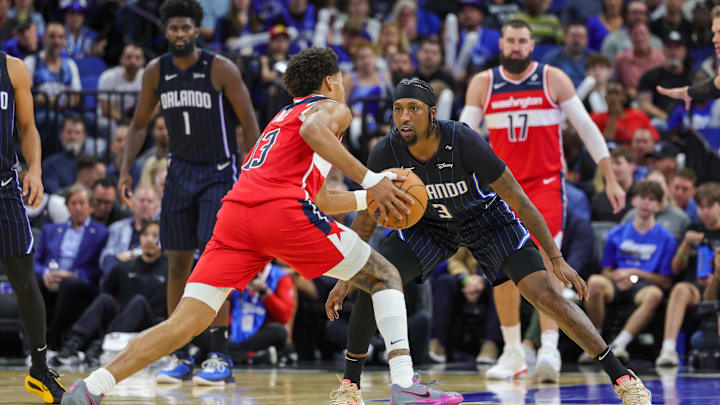 Nov 10, 2024; Orlando, Florida, USA; Orlando Magic guard Kentavious Caldwell-Pope (3) defends Washington Wizards guard Jordan Poole (13) during the second half at Kia Center. Mandatory Credit: Mike Watters-Imagn Images