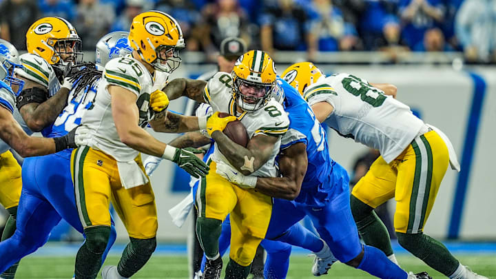 Green Bay Packers running back Josh Jacobs breaks a tackle against the Detroit Lions on Thursday Night Football