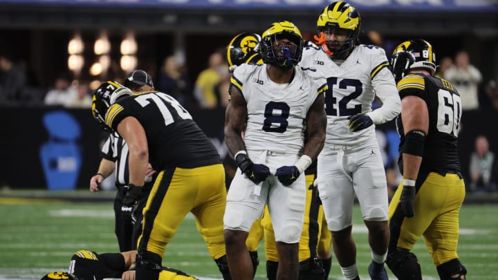 Dec 2, 2023; Indianapolis, IN, USA; Michigan Wolverines defensive end Derrick Moore (8) celebrates after sacking Iowa Hawkeyes quarterback Deacon Hill (10) during the second half of the Big Ten Championship game at Lucas Oil Stadium. Mandatory Credit: Trevor Ruszkowski-USA TODAY Sports