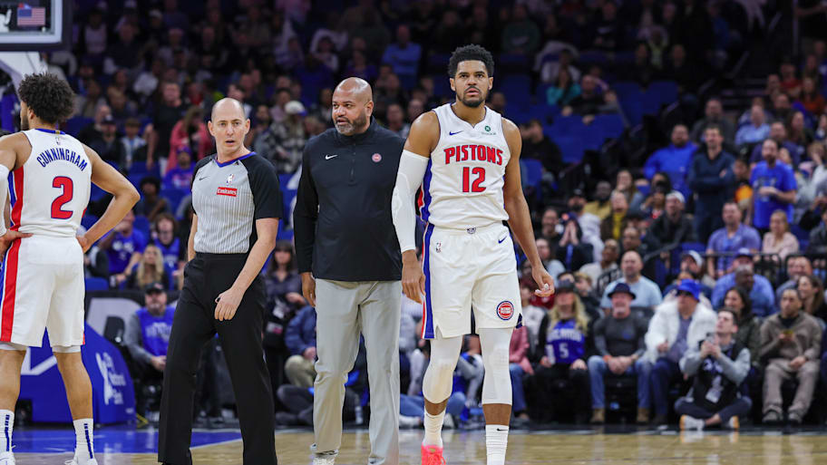 Detroit Pistons forward Tobias Harris is escorted off court by Detroit Pistons head coach J.B. Bickerstaff.