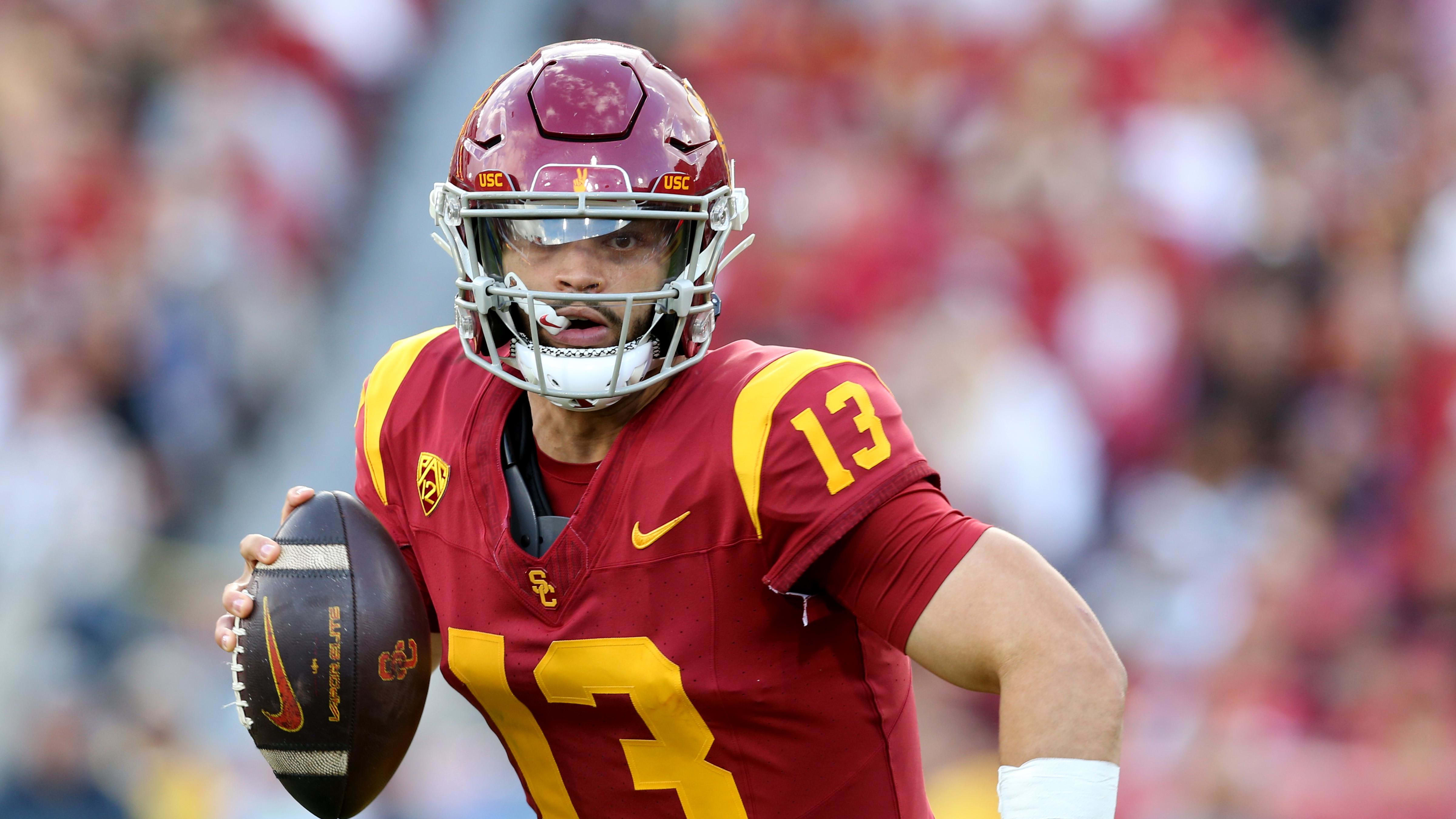 USC Trojans quarterback Caleb Williams scrambles out of the pocket and looks to pass.